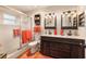 Bright bathroom with a double sink vanity, glass-enclosed shower, and stylish rustic decor at 9153 Sw 83Rd Ter # E, Ocala, FL 34481