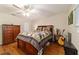Bedroom with hardwood floors, matching dresser, guitar, and decor at 9153 Sw 83Rd Ter # E, Ocala, FL 34481