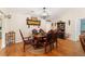 Elegant dining room with hardwood floors, a chandelier, a wooden dining set, and decorative wall accents at 9153 Sw 83Rd Ter # E, Ocala, FL 34481
