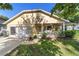Charming home featuring a covered front porch, attached garage, and lush lawn at 9153 Sw 83Rd Ter # E, Ocala, FL 34481
