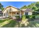 Charming yellow home with a welcoming front porch, lush landscaping, and inviting curb appeal at 9153 Sw 83Rd Ter # E, Ocala, FL 34481