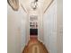 Charming hallway featuring hardwood floors and classic white closet doors that complement the bathroom at 9153 Sw 83Rd Ter # E, Ocala, FL 34481