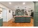 A full kitchen view shows a large island, dark green cabinetry, and hardwood floors at 9153 Sw 83Rd Ter # E, Ocala, FL 34481