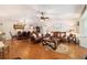An open living room is visible, featuring hardwood floors, two leather couches, and a dining room at 9153 Sw 83Rd Ter # E, Ocala, FL 34481