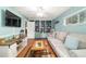 Comfortable living room featuring light blue walls, a large couch, and decorative shelving at 9153 Sw 83Rd Ter # E, Ocala, FL 34481