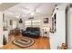 Cozy living room featuring laminate floors, two ceiling fans, and natural lighting at 9153 Sw 83Rd Ter # E, Ocala, FL 34481