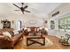Comfortable living room with a large window, hardwood floors, and two leather couches at 9153 Sw 83Rd Ter # E, Ocala, FL 34481