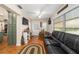 Inviting living area featuring a comfortable sofa, hardwood floors, and lots of natural light at 9153 Sw 83Rd Ter # E, Ocala, FL 34481