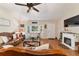 Comfortable living room with a cozy fireplace, bay window, and stylish leather furniture at 9153 Sw 83Rd Ter # E, Ocala, FL 34481