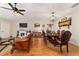 Open-concept living and dining area with hardwood floors, a fireplace, and an elegant dining set at 9153 Sw 83Rd Ter # E, Ocala, FL 34481