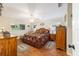 Comfortable main bedroom with a warm ambiance, natural light, and stylish furnishings at 9153 Sw 83Rd Ter # E, Ocala, FL 34481