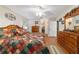 Spacious main bedroom with wood furniture, decorative bedding, and laminate flooring at 9153 Sw 83Rd Ter # E, Ocala, FL 34481