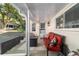 Covered outdoor patio space with red cushioned sofa and fire pit at 9153 Sw 83Rd Ter # E, Ocala, FL 34481