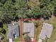 Aerial photo of a single-story home with a well-maintained yard, bordered by lush greenery, showcasing property lines at 9325 Se 132Nd Pl, Summerfield, FL 34491