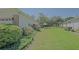 Spacious backyard with lush lawn, mature trees, and meticulously maintained landscaping at 9325 Se 132Nd Pl, Summerfield, FL 34491