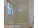 Cozy bathroom featuring a glass door shower and a vanity mirror with bright lights at 9325 Se 132Nd Pl, Summerfield, FL 34491