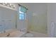 Cozy bathroom featuring a glass door shower and a vanity mirror with bright lights at 9325 Se 132Nd Pl, Summerfield, FL 34491