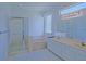 Bright bathroom features double sinks, a tub, and a glass-enclosed shower at 9325 Se 132Nd Pl, Summerfield, FL 34491