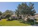 Well-maintained single-story home featuring lush front lawn with mature trees and an attached two-car garage at 9325 Se 132Nd Pl, Summerfield, FL 34491