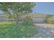 Charming single-story home with a well-manicured lawn, mature landscaping, and attached two-car garage at 9325 Se 132Nd Pl, Summerfield, FL 34491
