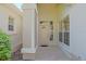 Welcoming front porch with decorative columns, sidelight windows, and neutral paint at 9325 Se 132Nd Pl, Summerfield, FL 34491