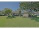 Charming single-story home with lush green lawn, mature trees, and well-maintained landscaping at 9325 Se 132Nd Pl, Summerfield, FL 34491