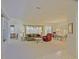 Bright and spacious living room featuring neutral carpet, and an adjacent dining area at 9325 Se 132Nd Pl, Summerfield, FL 34491