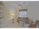 Cozy living room featuring a floral sofa, accent chair, and built-in bookshelves at 9325 Se 132Nd Pl, Summerfield, FL 34491