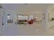 Expansive living room with neutral carpet, ceiling fan, and adjacent dining area at 9325 Se 132Nd Pl, Summerfield, FL 34491