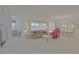 Bright living room features neutral colors, a ceiling fan, and access to dining area at 9325 Se 132Nd Pl, Summerfield, FL 34491