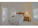 Well-lit main bedroom with doorway to attached main bathroom at 9325 Se 132Nd Pl, Summerfield, FL 34491