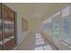 Enclosed patio area with tile flooring, ceiling fan, and multiple windows offering views at 9325 Se 132Nd Pl, Summerfield, FL 34491