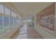 Spacious enclosed patio offers tile flooring, multiple windows, and a ceiling fan at 9325 Se 132Nd Pl, Summerfield, FL 34491