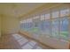 Enclosed patio with tile flooring, abundant natural light, and views of the backyard at 9325 Se 132Nd Pl, Summerfield, FL 34491