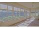 Bright enclosed patio features tile flooring, ceiling fan, and large windows with outdoor views at 9325 Se 132Nd Pl, Summerfield, FL 34491