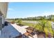 Spacious backyard features a brick patio, palm trees, and a white fence at 9573 Sw 79Th Loop, Ocala, FL 34481