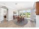 Elegant dining room featuring wood floors, a round table, and large windows at 9573 Sw 79Th Loop, Ocala, FL 34481