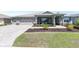 Charming single-story home with a well-manicured lawn, three-car garage, and inviting front porch at 9573 Sw 79Th Loop, Ocala, FL 34481