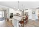 Bright kitchen with a large center island, white cabinets, and modern appliances at 9573 Sw 79Th Loop, Ocala, FL 34481