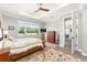 Spacious main bedroom features wood floors, tray ceiling, and a large window overlooking the backyard at 9573 Sw 79Th Loop, Ocala, FL 34481