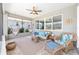 Relaxing patio features comfortable seating, ceiling fan, and a view of the backyard at 9573 Sw 79Th Loop, Ocala, FL 34481