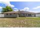 View of the backyard with solar panels, patio, landscaping and white fence at 9896 Sw 56Th Ct, Ocala, FL 34476