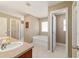 Bright bathroom featuring a soaking tub, vanity, and ceramic tile flooring at 9896 Sw 56Th Ct, Ocala, FL 34476