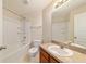 Bright bathroom with combined shower-tub, vanity with sink, and neutral decor at 9896 Sw 56Th Ct, Ocala, FL 34476