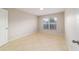 Neutral bedroom with a window providing natural light and tile flooring at 9896 Sw 56Th Ct, Ocala, FL 34476