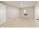 Neutral bedroom features tile flooring and a bright sunny window at 9896 Sw 56Th Ct, Ocala, FL 34476