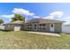 Backyard view of the home with solar panels, patio, and fenced in yard at 9896 Sw 56Th Ct, Ocala, FL 34476