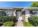 Close up of an attractive home entry featuring a decorative archway, elegant sidelights, and lush landscaping at 9896 Sw 56Th Ct, Ocala, FL 34476