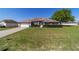 Charming single-story home with manicured lawn, mature landscaping, and an attached two-car garage at 9896 Sw 56Th Ct, Ocala, FL 34476