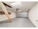 Spacious garage with gray flooring, ladder to attic, and an automatic door at 9896 Sw 56Th Ct, Ocala, FL 34476